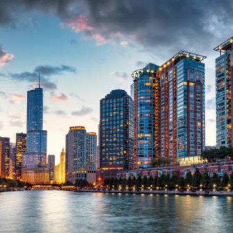 Chicago Urban Cityscape Sunset Twilight Panorama. Illuminated Chicago Urban Skyscrapers along the Chicago River. View from the Chicago River Waterfront at sunset twilight. Trump International Hotel and Tower in the background. Chicago, Illinois, USA, North America.