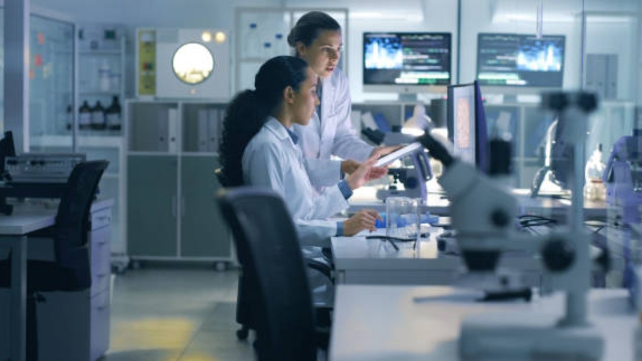 Drug trial, medical research or examination of a scan being done by doctors, researchers or scientists in a lab. Experts, medical professionals or biologists talking and discussing results of a test